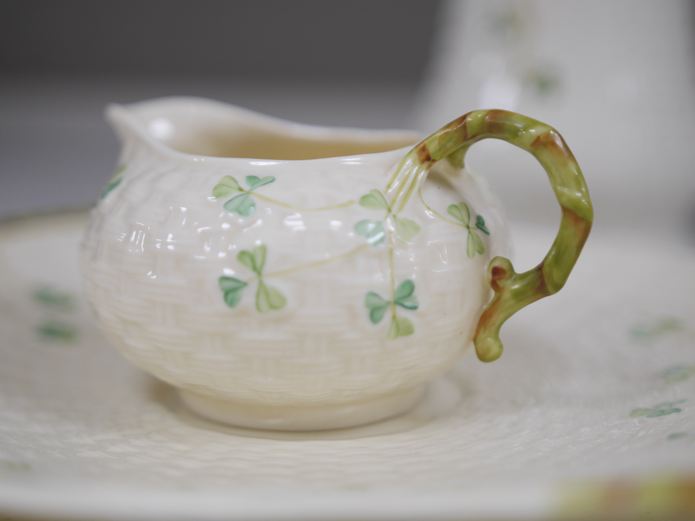 A Belleek serving plate, milk jug and two bowls and three Donegal vases, tallest item 25cm high. Condition - good